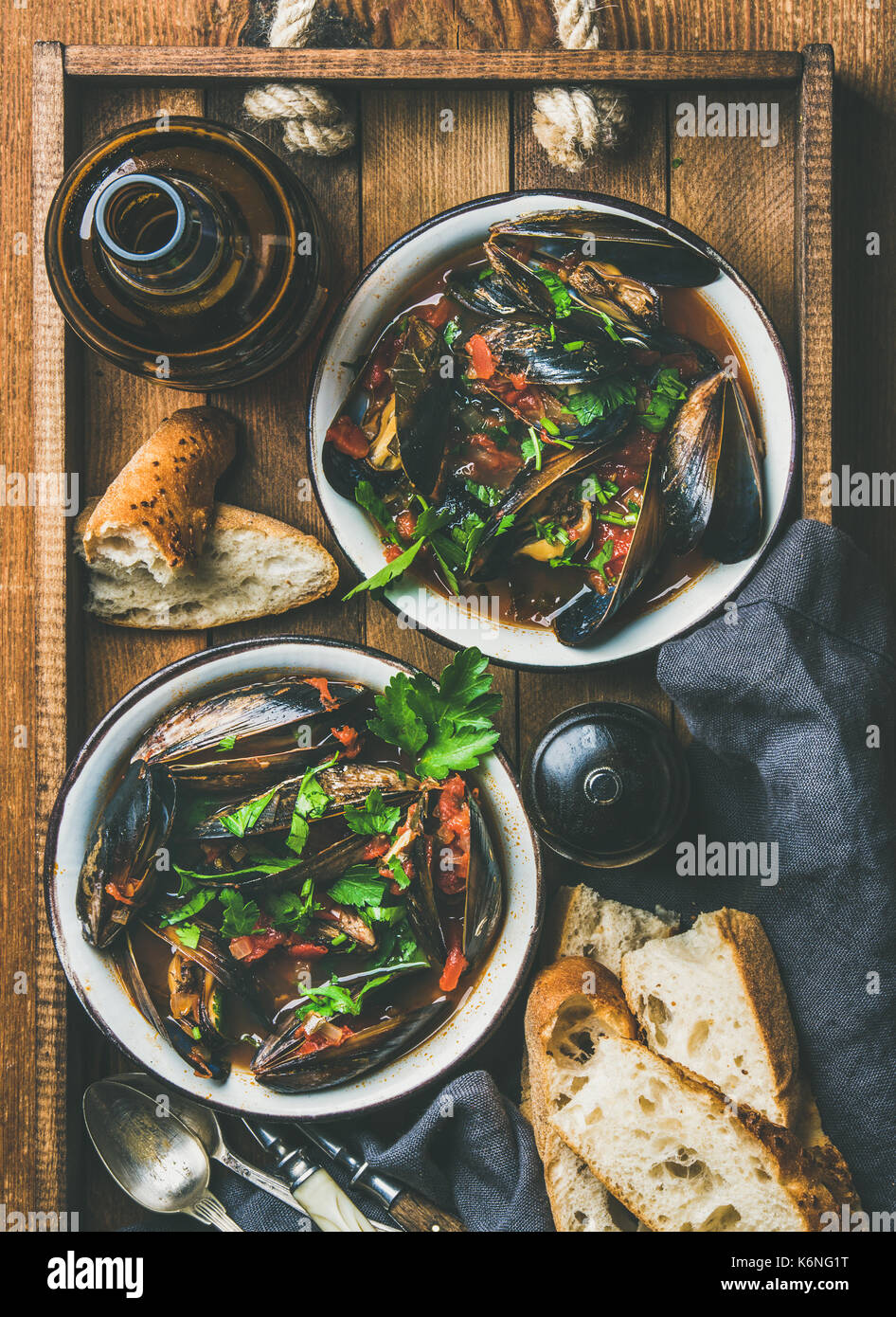 Flatlay of boiled mussels in tomato sauce and light beer Stock Photo