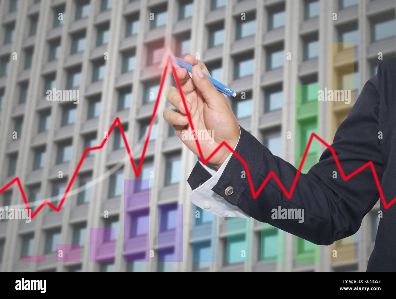 hand of businessman use red pen point to top line graph in concept of ...