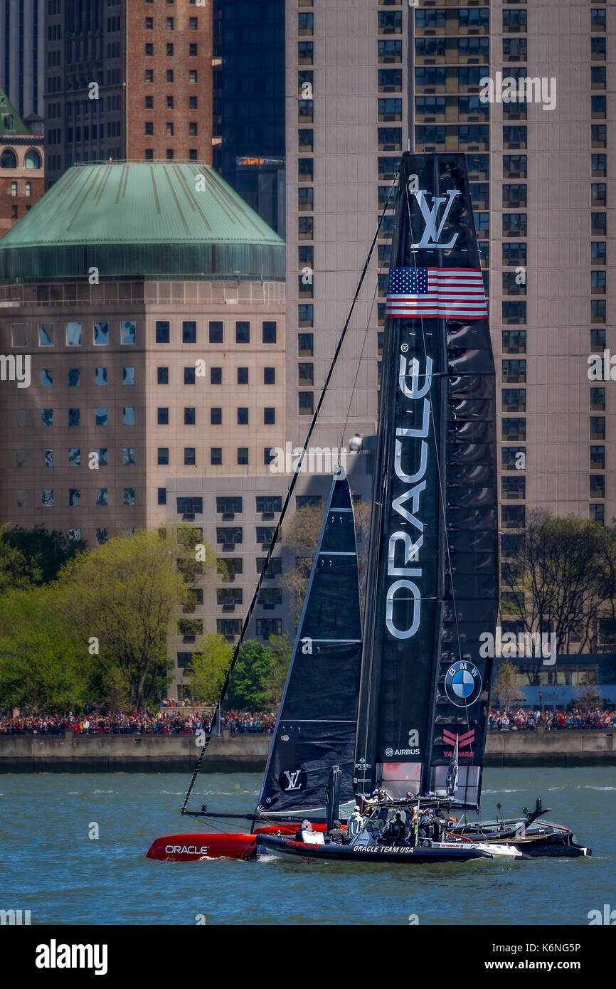 Oracle Team USA America's Cup NYC - Catamaran sails on the Hudson River by the Lower Manhattan skyline during the Louis Vuitton America's Cup in New York City. Available in color and black and white. To view additional images please visit www.susancandelario.com Stock Photo