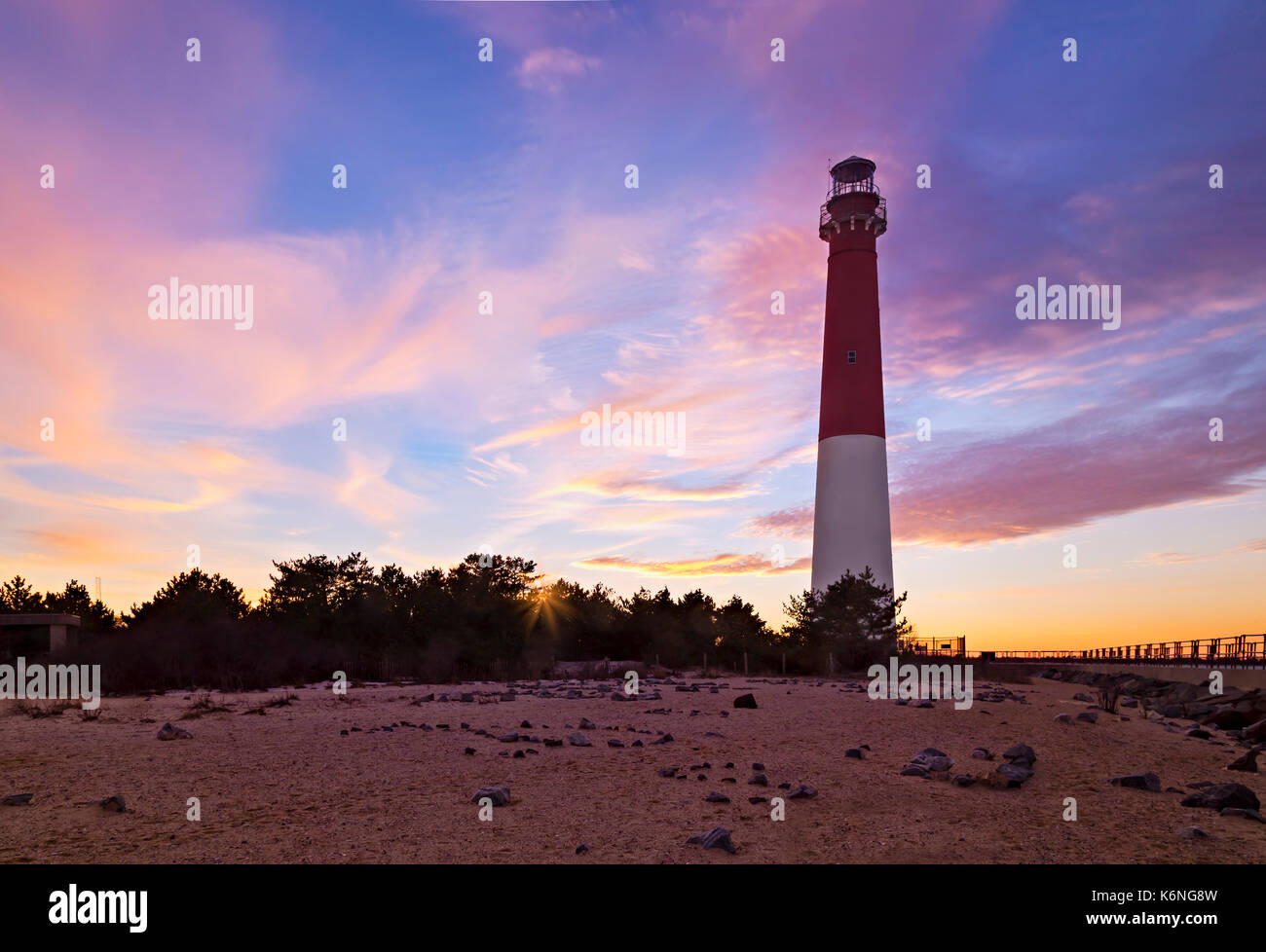 Barnegat Bay Light Sunset - Barnegat Lighthouse or Barnegat Light, colloquially known as 'Old Barney', is a historic lighthouse located in Barnegat Lighthouse State Park on the northern tip of Long Beach Island (LBI), in  Ocean County, New Jersey. Stock Photo
