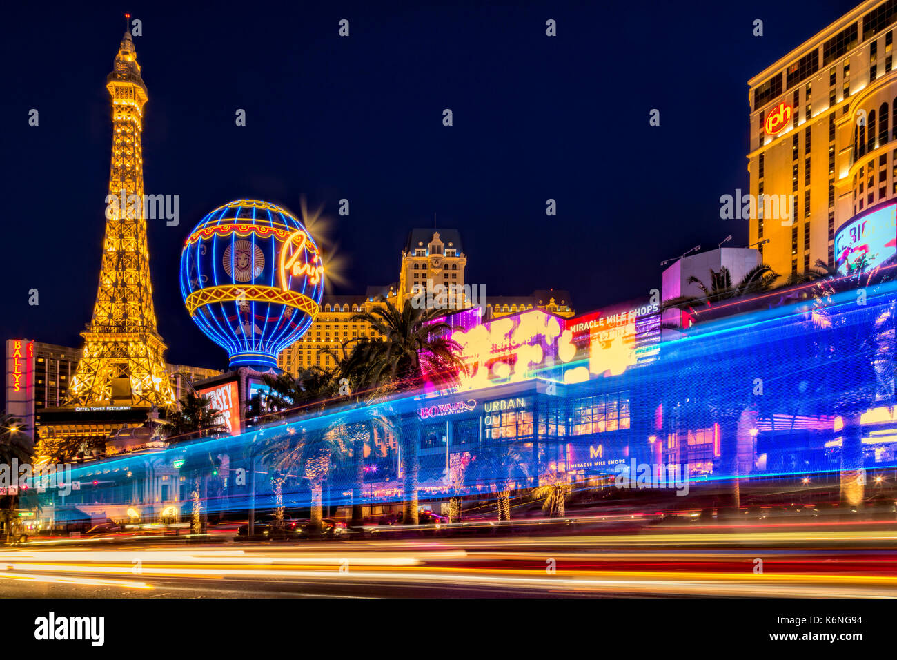 Las Vegas Strip Light Show -  Light streaks from vehicular traffic in the Las Vegas Strip in Nevada along with the illuminated Paris Las Vegas Hotel a Stock Photo