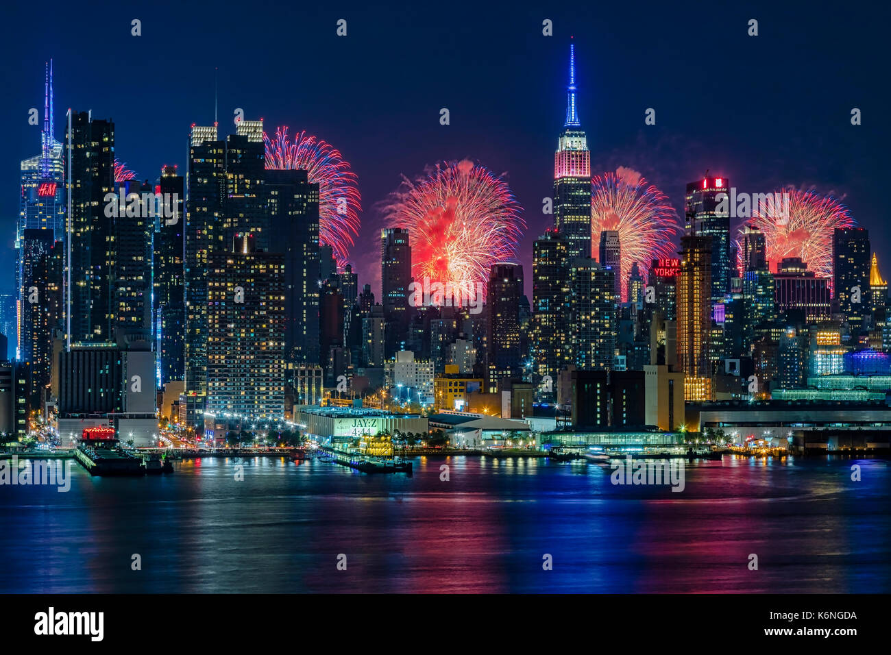 NYC Fireworks Celebration -  New York City skyline with the Macy's Spectacular 4th of July Fireworks Celebration Show as a backdrop to midtown Manhattan. Stock Photo