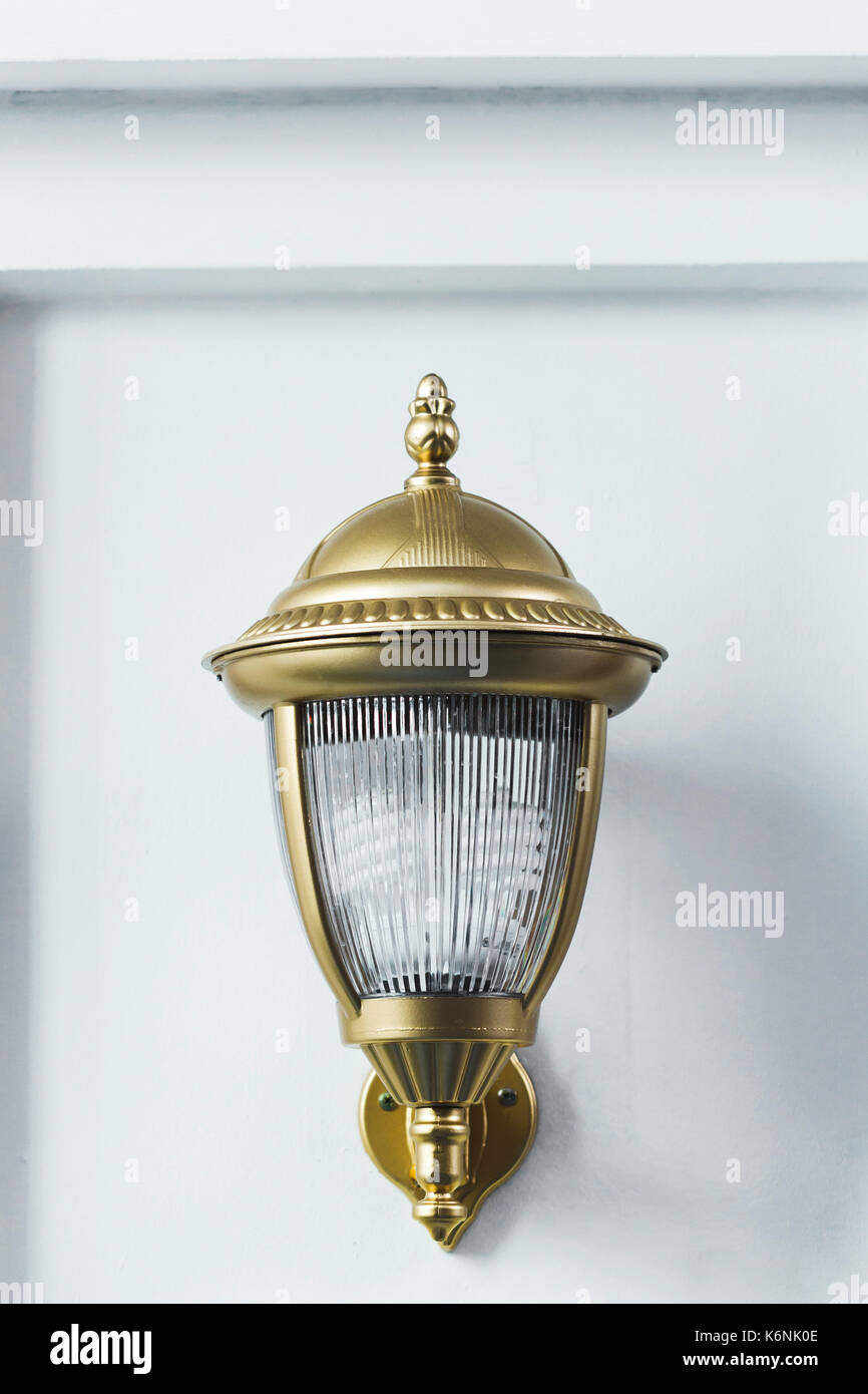 Beautiful modern metal lantern on the house wall. Handmade, forging metal. Stock Photo