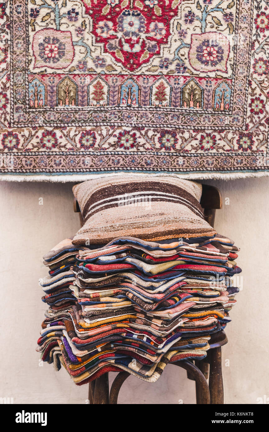 Pile of beautiful handmade carpets on the market in Istanbul Grand