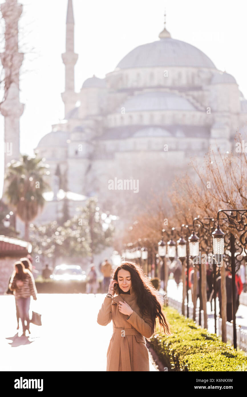 Woman in black coat walks hi-res stock photography and images - Alamy