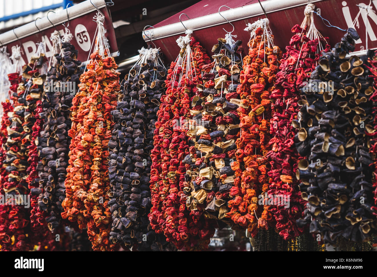Dried fruits and vegetables sold in the market, hanging on the counter
