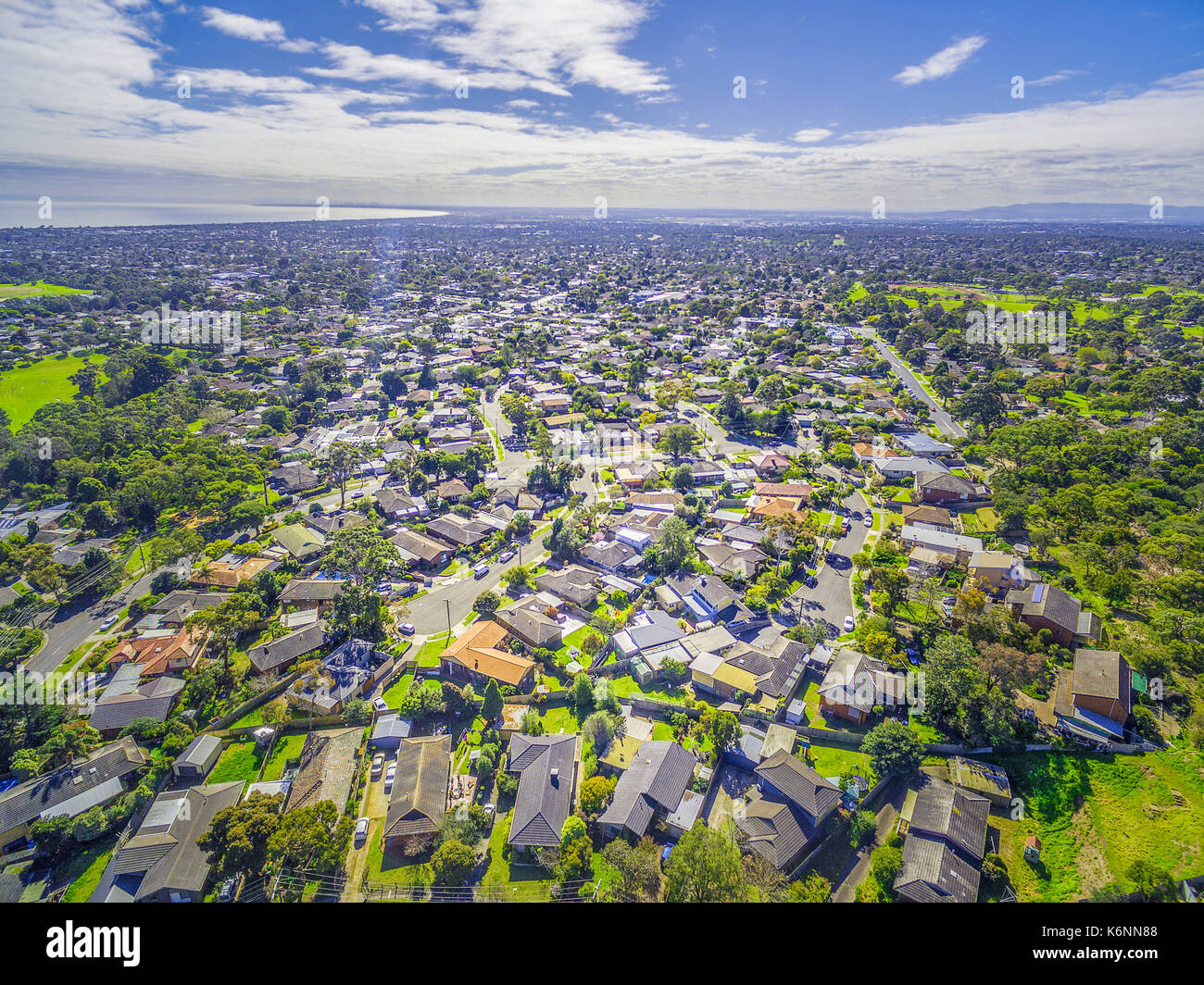 Aerial panorama of town houses near ocean bay on bright sunny day Stock Photo