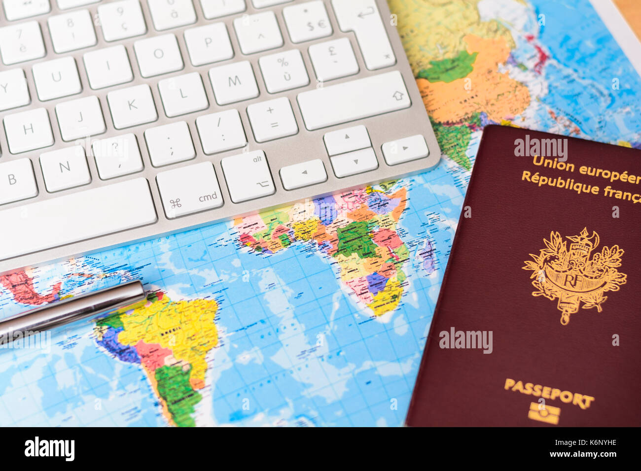 World's map with keyboard, passport and pen Stock Photo