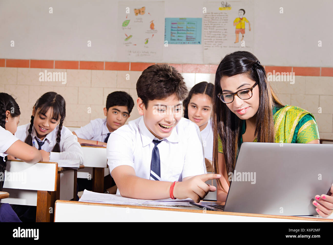 Indian School Boy Student And Teacher Laptop Studying E-Learning In Class Stock Photo