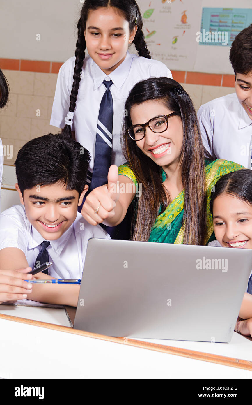 Indian High School Students And Teacher LaptopThumbs up Success Studying E-Learning In Classroom Stock Photo
