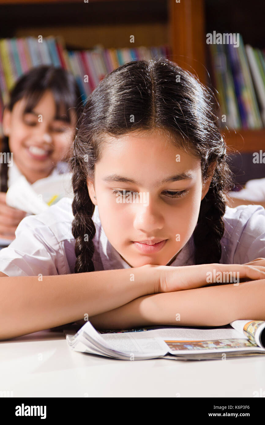 1 Indian School Girl Student Reading Book Study Education In Library Exam Preparing Stock Photo