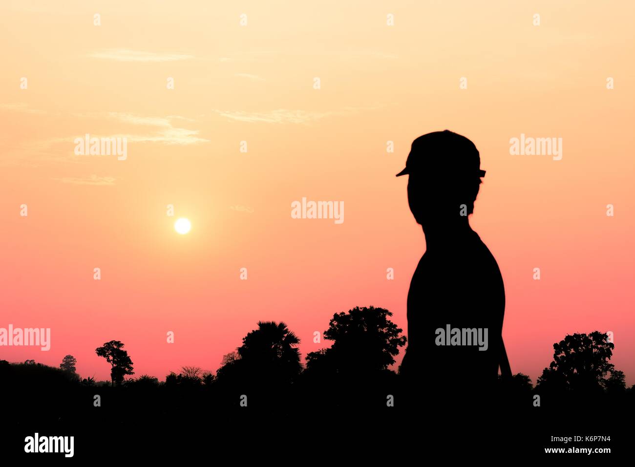 Silhouette of a man look at the sunset Stock Photo - Alamy