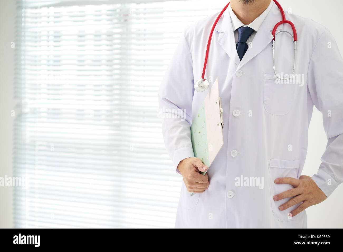 Doctor with a stethoscope and taking notes with bright background . Stock Photo