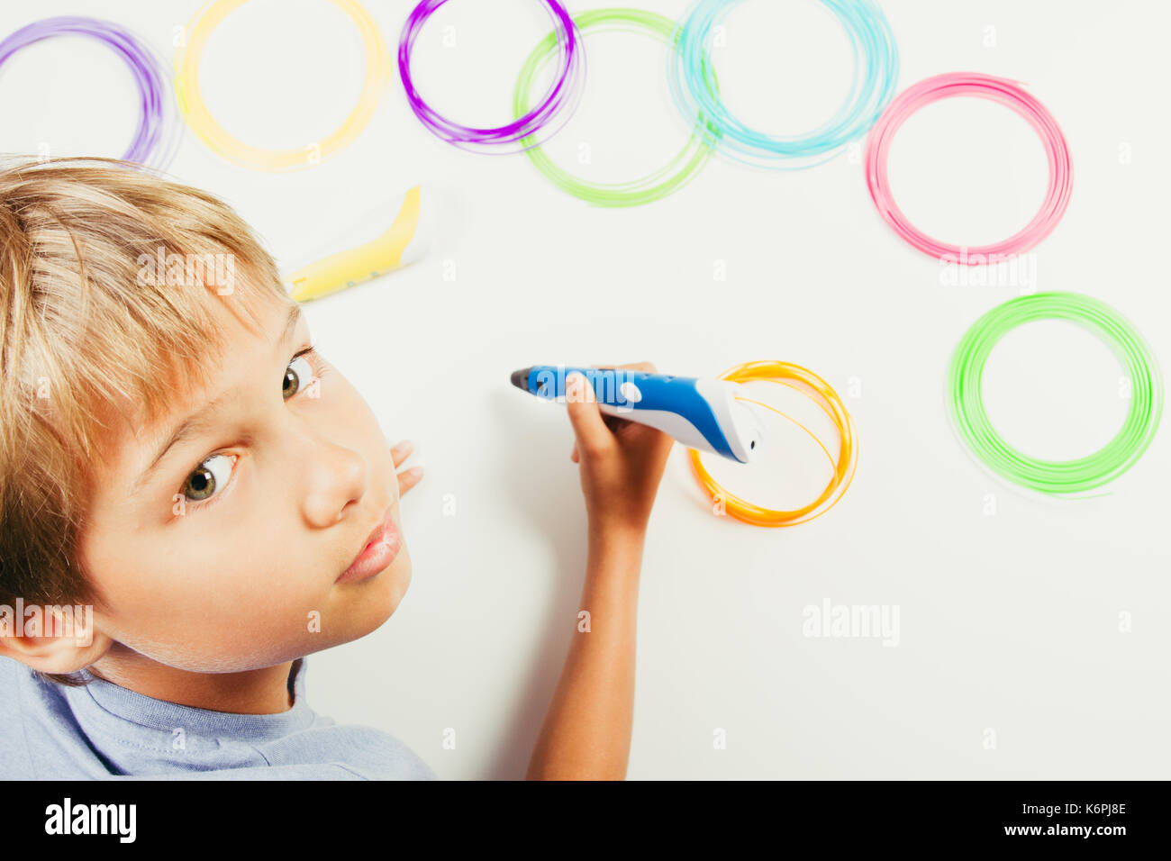Kid creating with 3d printing pens Stock Photo - Alamy