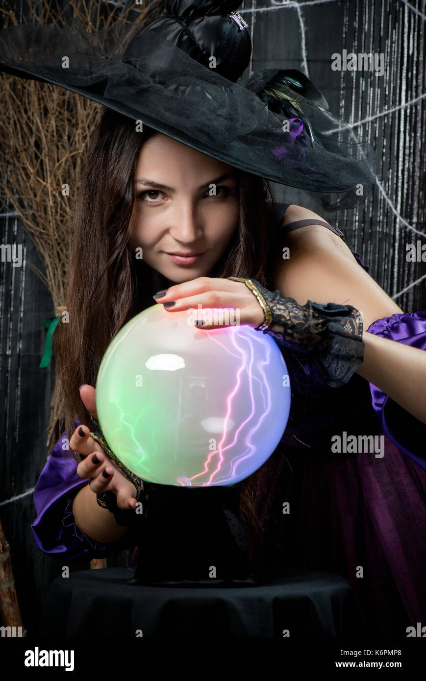 portrait of a witch with a magic ball for predictions Stock Photo