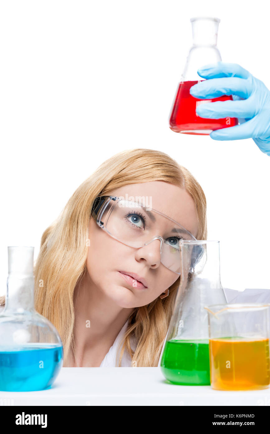 The chemist in glasses analyzes a liquid in test tubes is isolated