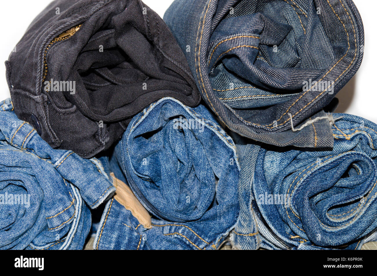 roll denim jeans stack on white background Stock Photo