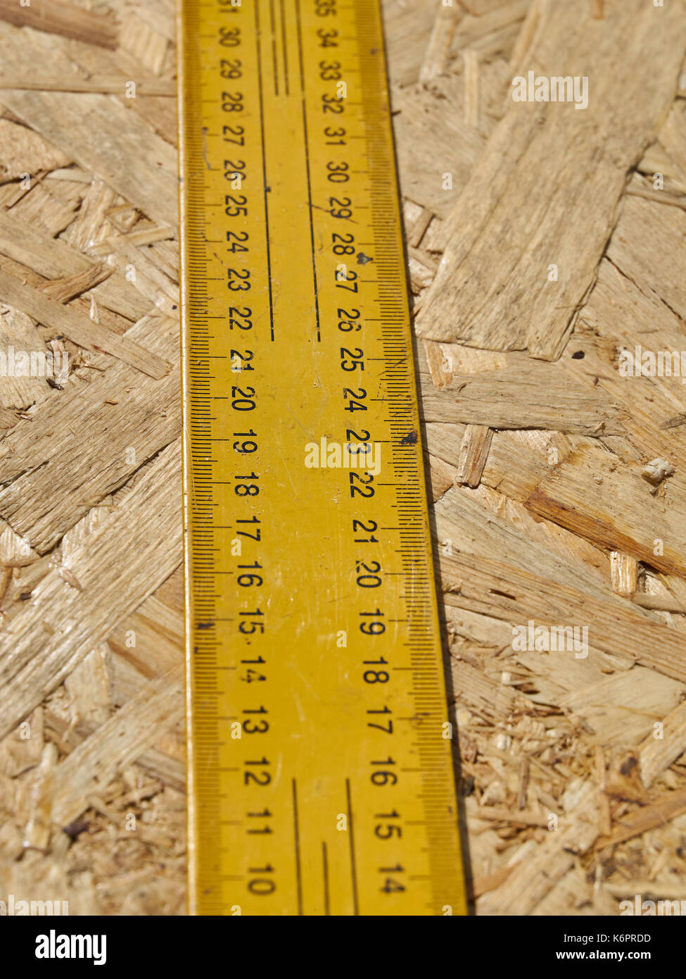 Ruler Using Construction Construction ruler on a wooden background Stock Photo - Alamy