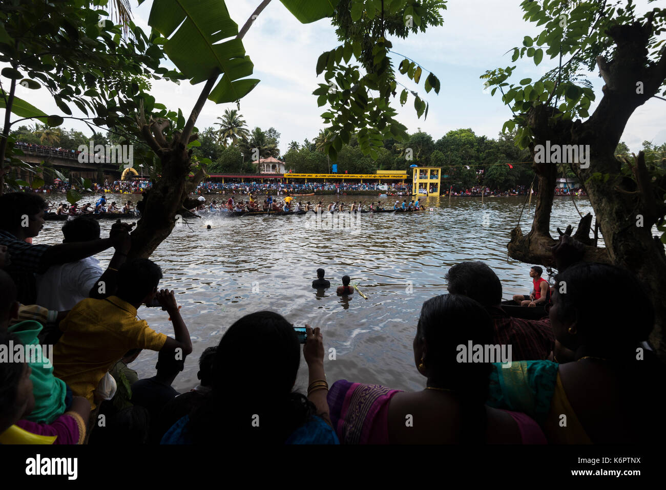 Villagers watching the race from the banks of the river. Stock Photo