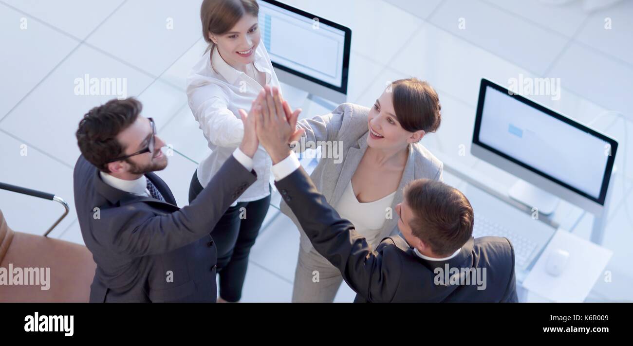 successful business team giving each other a high-five, standing in the ...