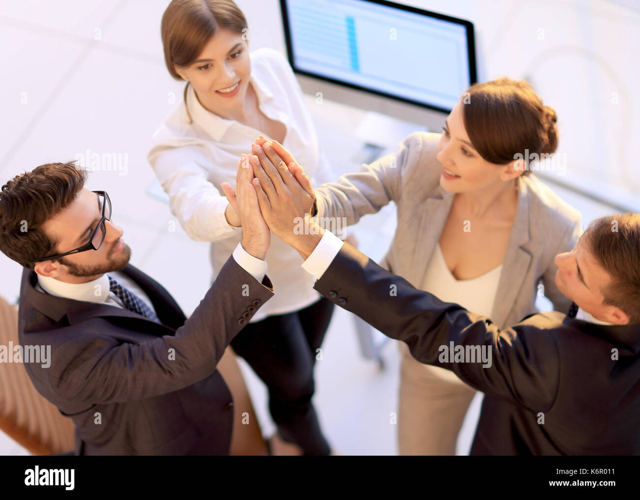 successful business team giving each other a high-five, standing in the ...