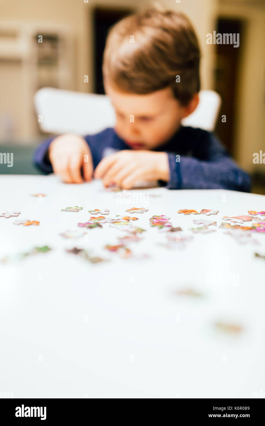 2 year old child solving jigsaw puzzle Stock Photo - Alamy