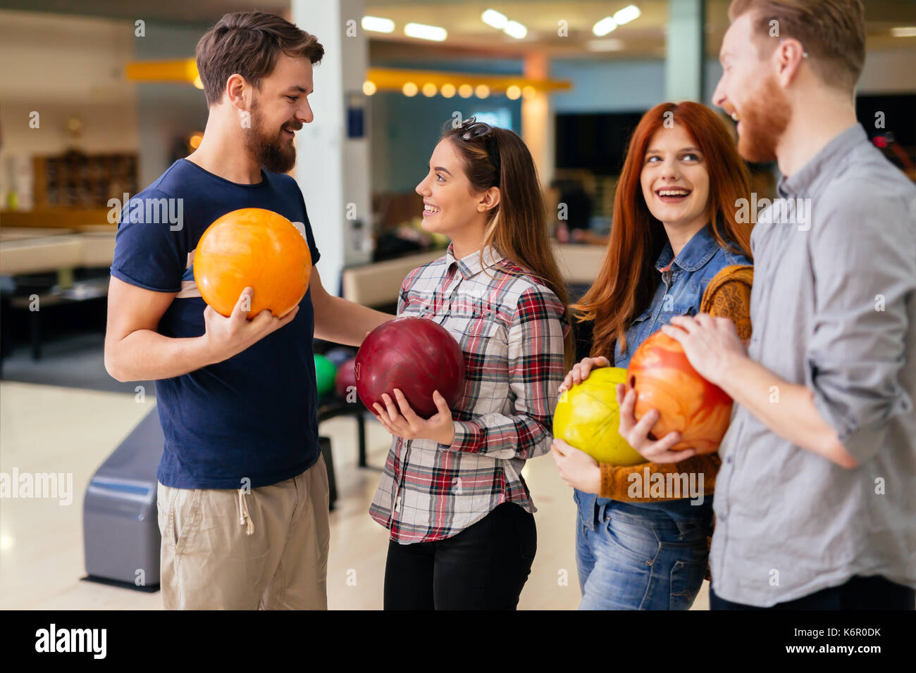 Friends having great time playing bowling Stock Photo