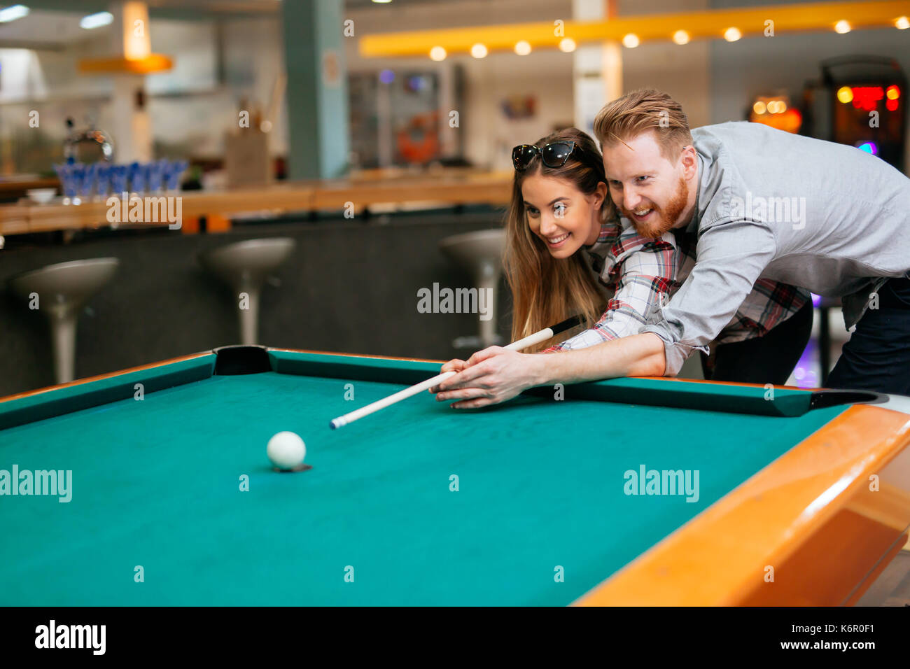 Couple flirting while playing snooker Stock Photo