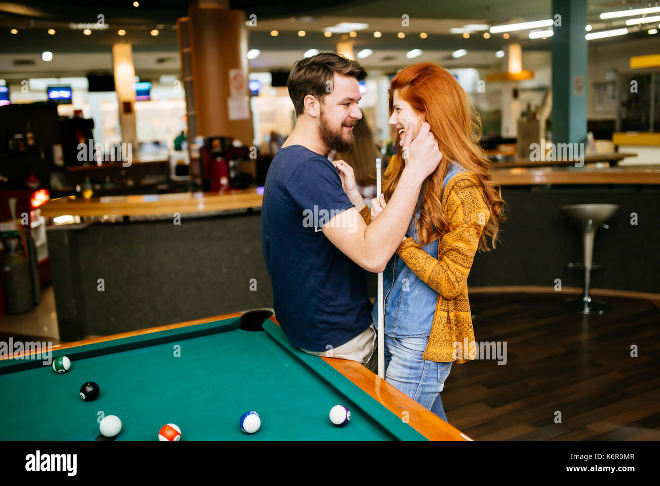 Couple hugging in snooker bar Stock Photo