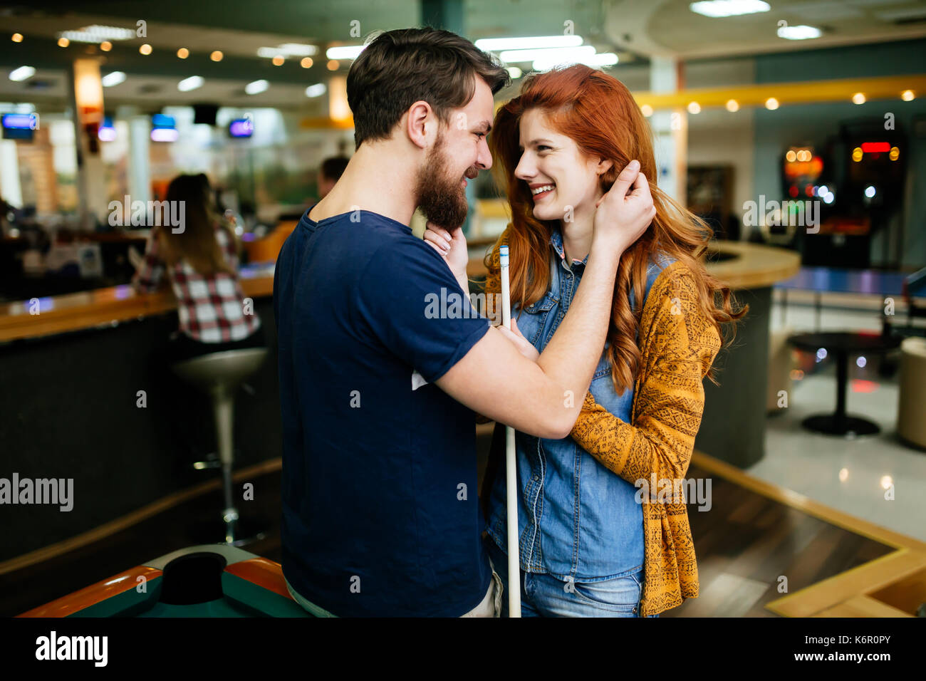 Couple hugging in snooker bar Stock Photo
