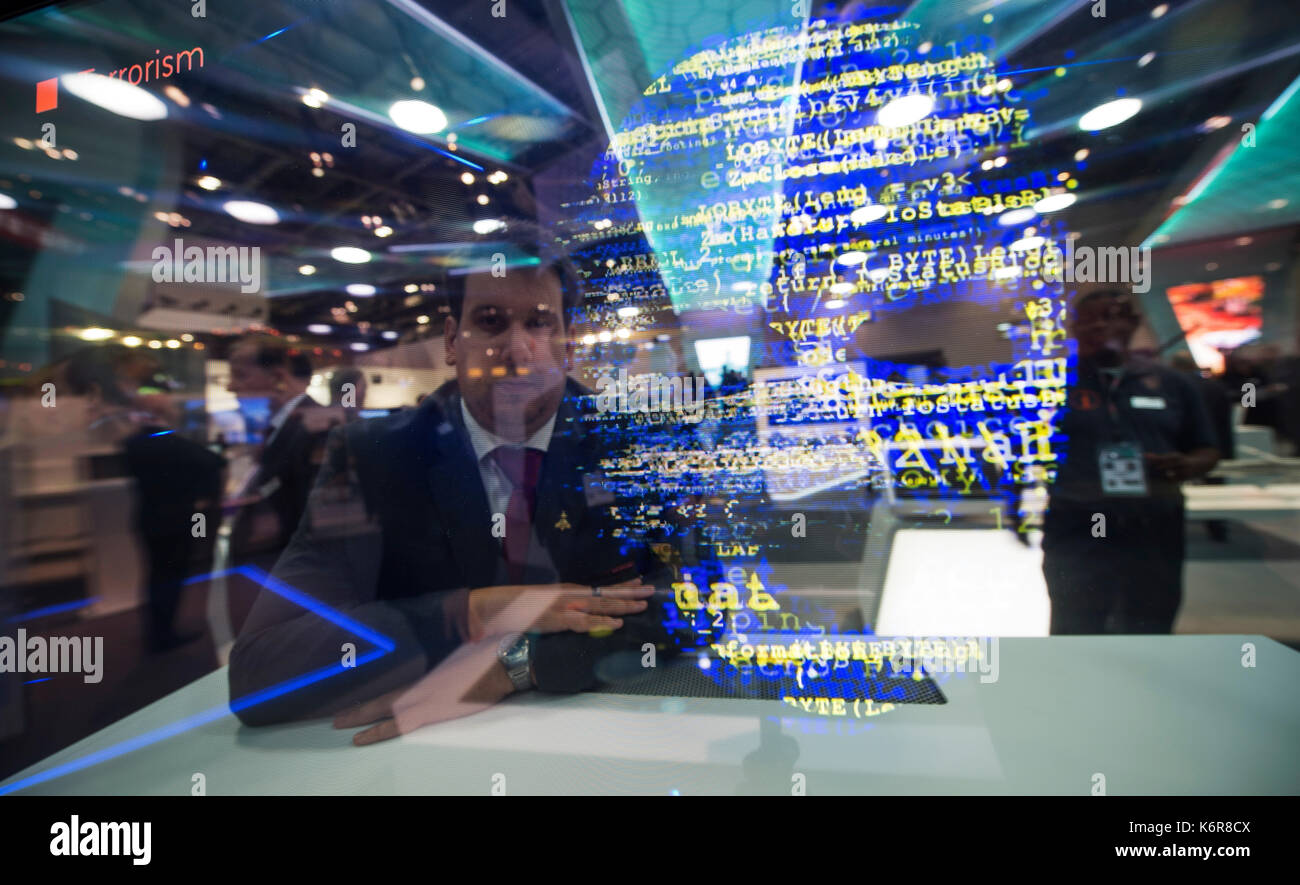 ExCel, London, UK. 13th Sep, 2017. Defence and Security Equipment International (DSEI), the worlds leading global defence and security event runs from 12-15 September 2017 showcasing the latest equipment and systems. A member of the BAE Systems team watches a presentation on Terrorism, Hacking and State Sponsored Espionage on the BAE stand. Credit: Malcolm Park/Alamy Live News. Stock Photo