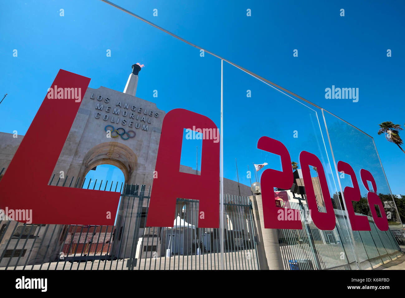 Los Angeles, USA. 13th Sep, 2017. A sign writing 'LA 2028' and a blazing Olympic cauldron are seen at the Los Angeles Memorial Coliseum, the United States, Sept. 13, 2017. The cauldron was lit early Wednesday morning at the stadium that was the site of the 1932 and 1984 Olympics. The International Olympic Committee (IOC) voted Los Angeles as the host city of the 2028 Summer Olympic Games on Sept.13. Credit: Zhao Hanrong/Xinhua/Alamy Live News Stock Photo