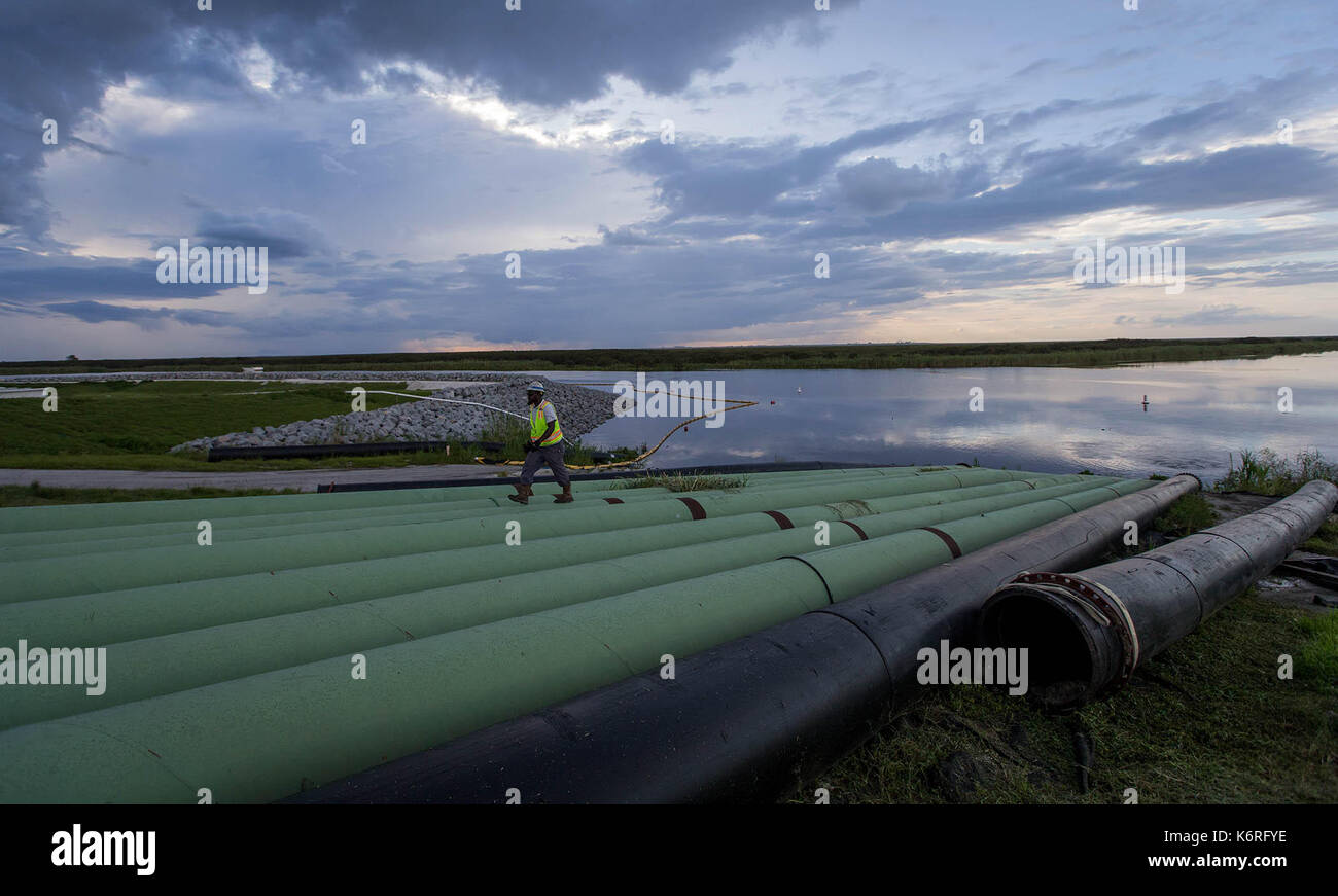 Belle Glade, Florida, USA. 13th Sep, 2017. A worker checks bypass pipes at the Herbert Hoover Dike culvert 12A replacement project. Debris from Hurricane Irma was cleaned out of the bypass pipes so that canal water can be pumped into Lake Okeechobee near Belle Glade, Florida on September 13, 2017. Credit: Allen Eyestone/The Palm Beach Post/ZUMA Wire/Alamy Live News Stock Photo