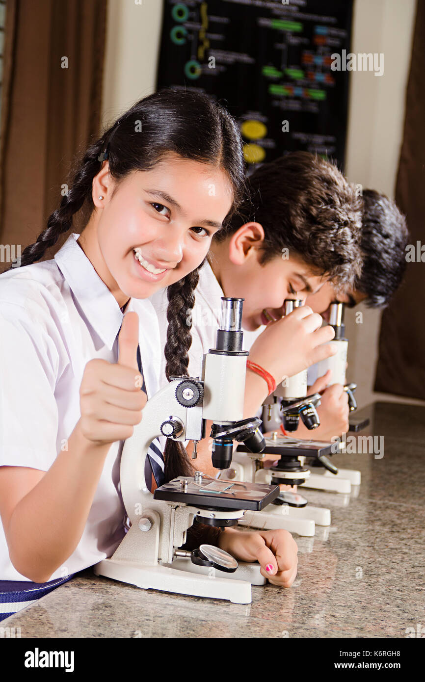 3 Indian School Students Studying Microscope Science Lab Research And