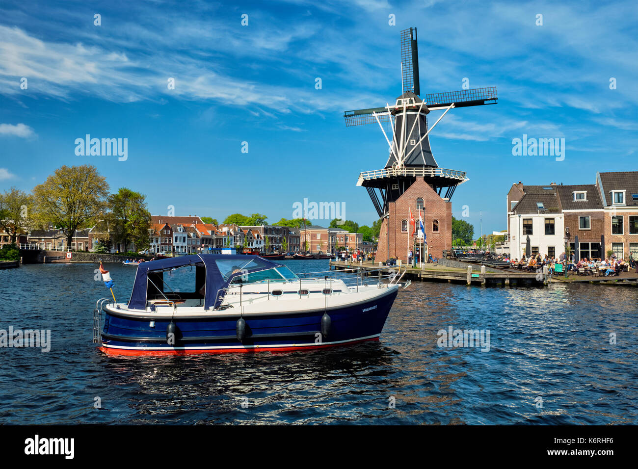 Harlem landmark windmill De Adriaan and boat on Spaarne river. Stock Photo