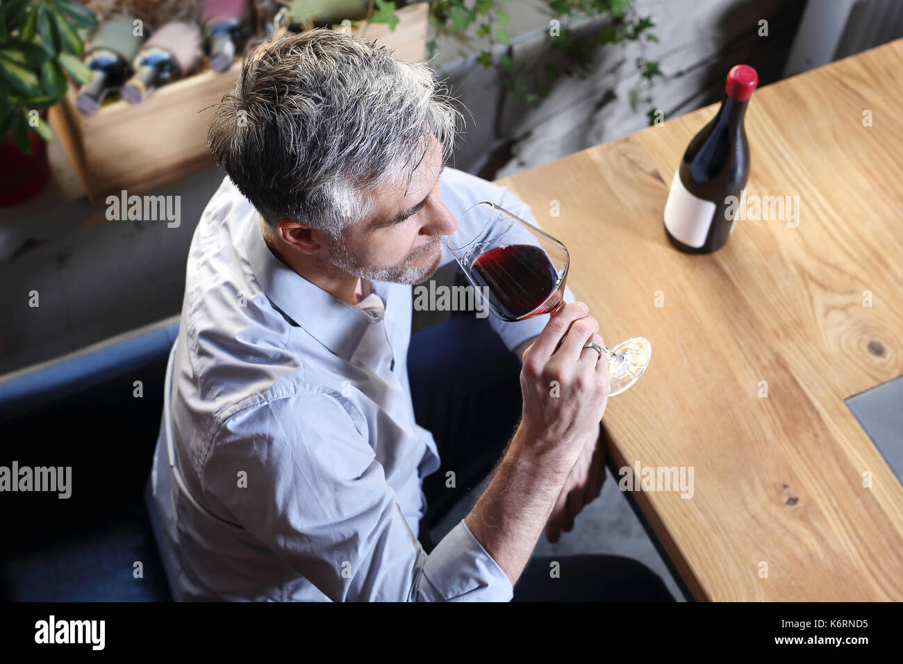 Drinking wine in a restaurant. Man drinking wine Stock Photo - Alamy