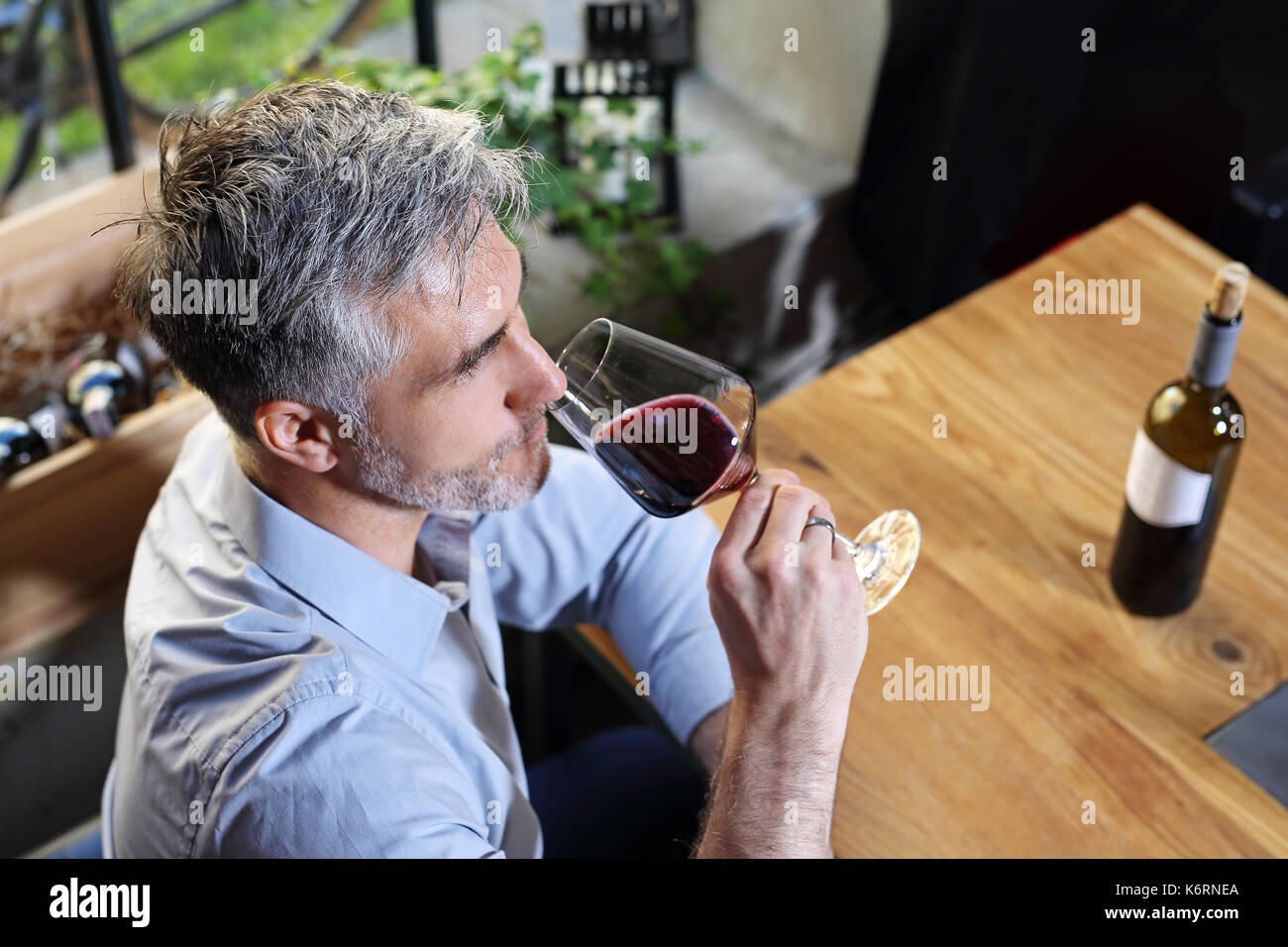 Drinking wine in a restaurant. Man drinking wine Stock Photo - Alamy