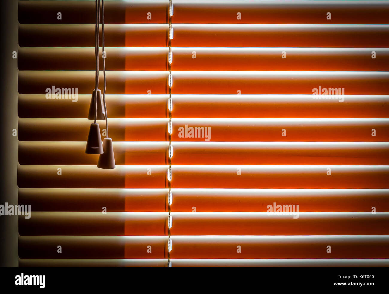 Orange plastic horizontal blinds close-up as a background. Stock Photo