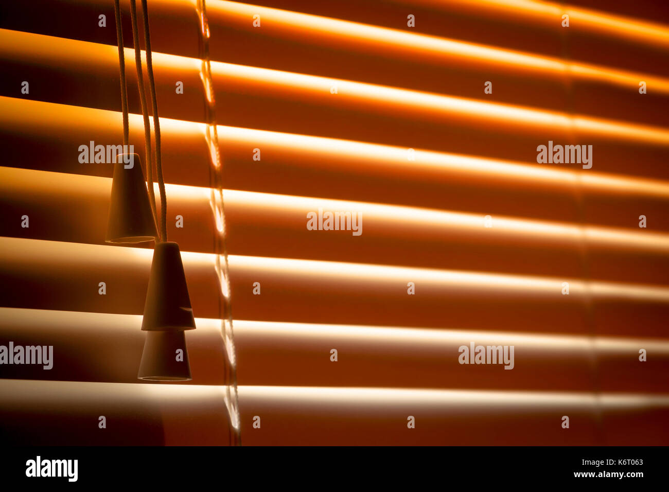Orange plastic horizontal blinds close-up as a background. Stock Photo