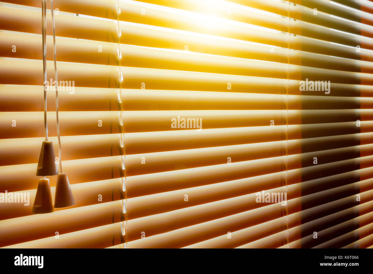 Orange plastic horizontal blinds close-up as a background. Stock Photo