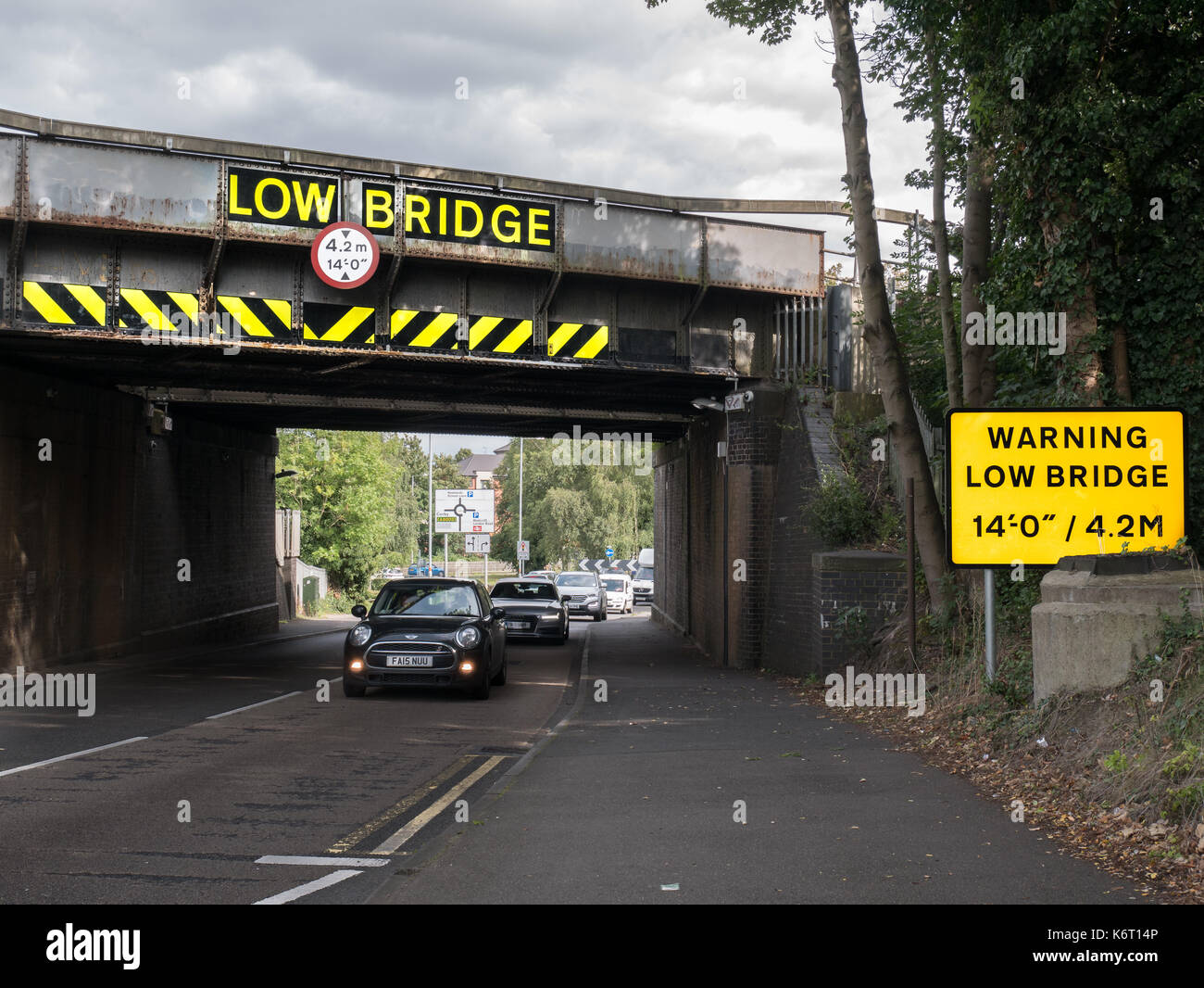 Warning about low railway bridge at lower (east) end of Rothwell road (Warren Hill), near the town centre, Kettering, England, september 2017. Stock Photo