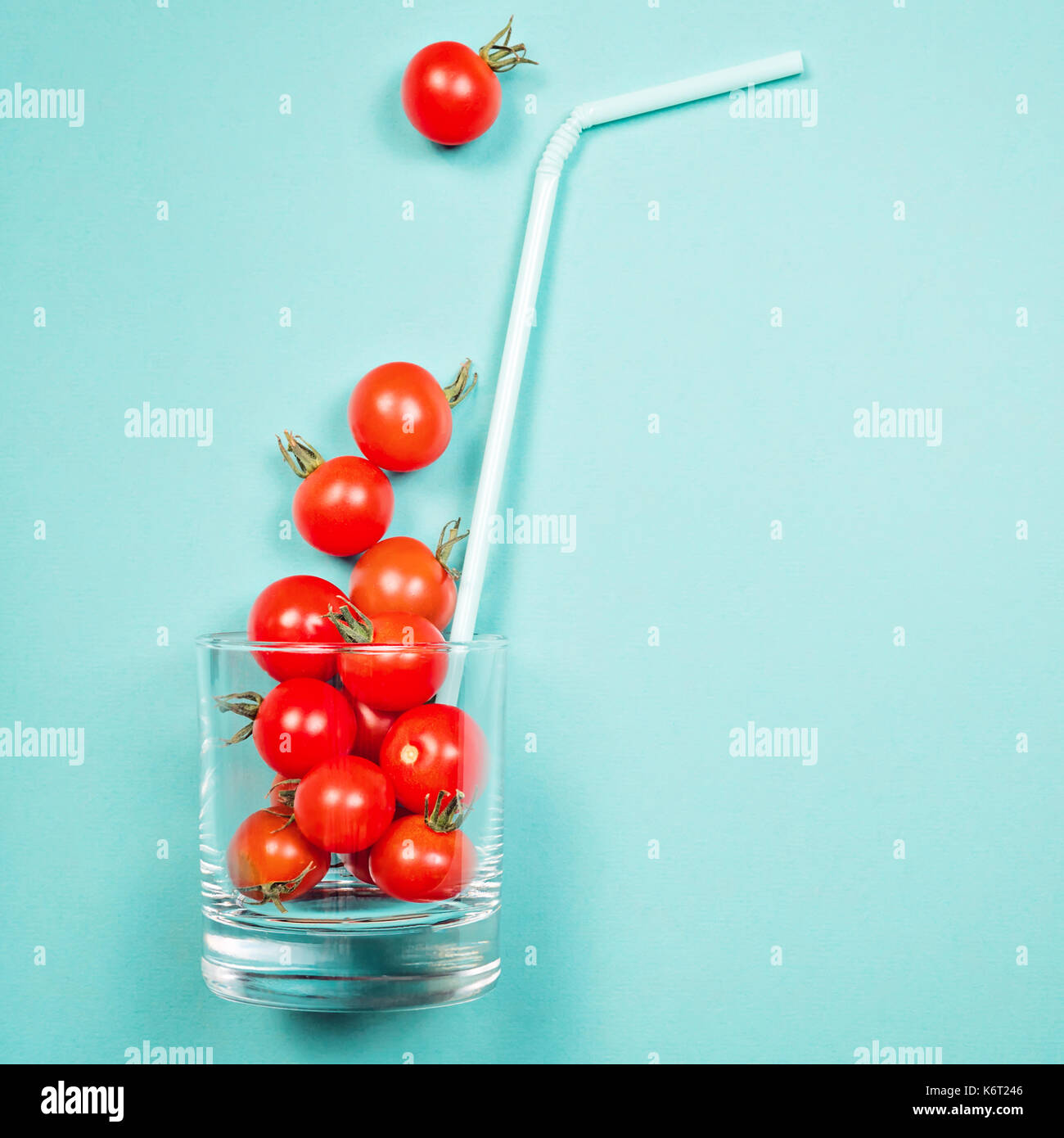 Tomato juice or smoothie, cherry tomato in drink glass with straw Stock