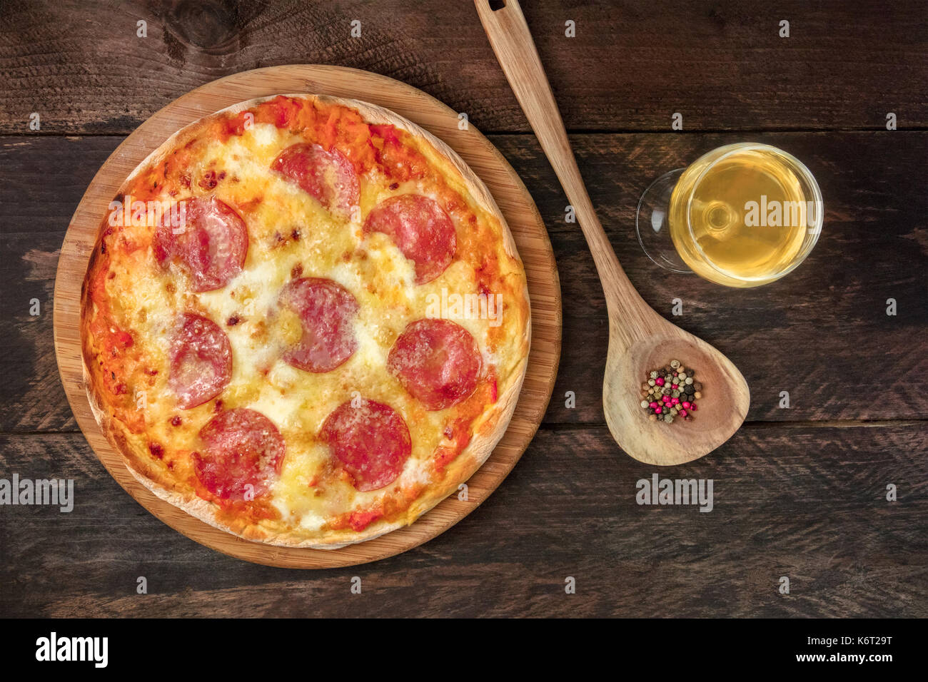 Pepperoni pizza with white wine, peppercorns, and copyspace Stock Photo