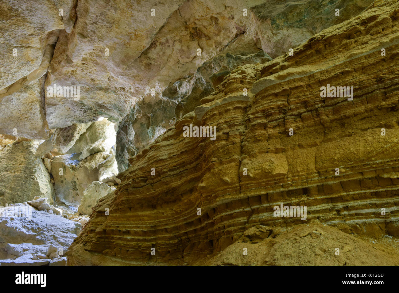 Cliff side cave, formed by sea erosion, containing evidence of