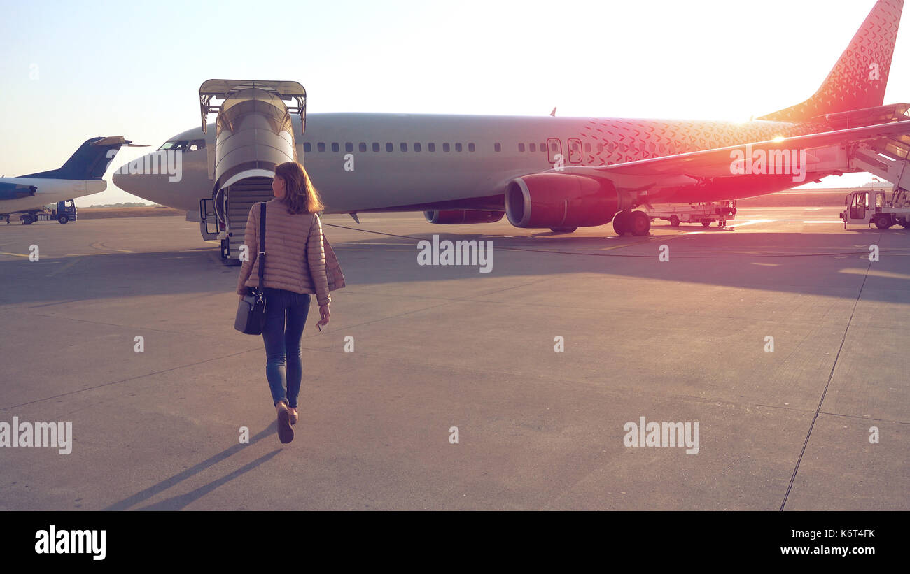 Woman going to plane an aerodrome Stock Photo