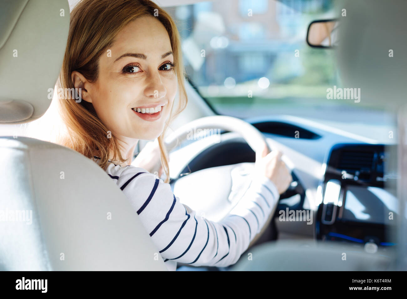 Happy pleasant woman turning to you Stock Photo - Alamy