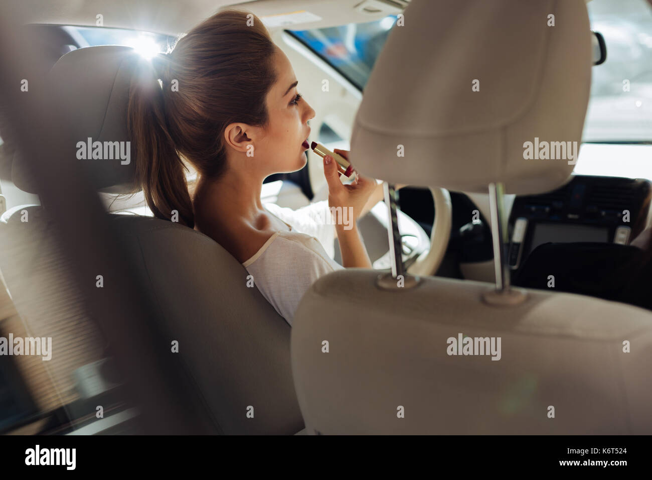 Attractive pretty woman sitting behind the wheel Stock Photo - Alamy