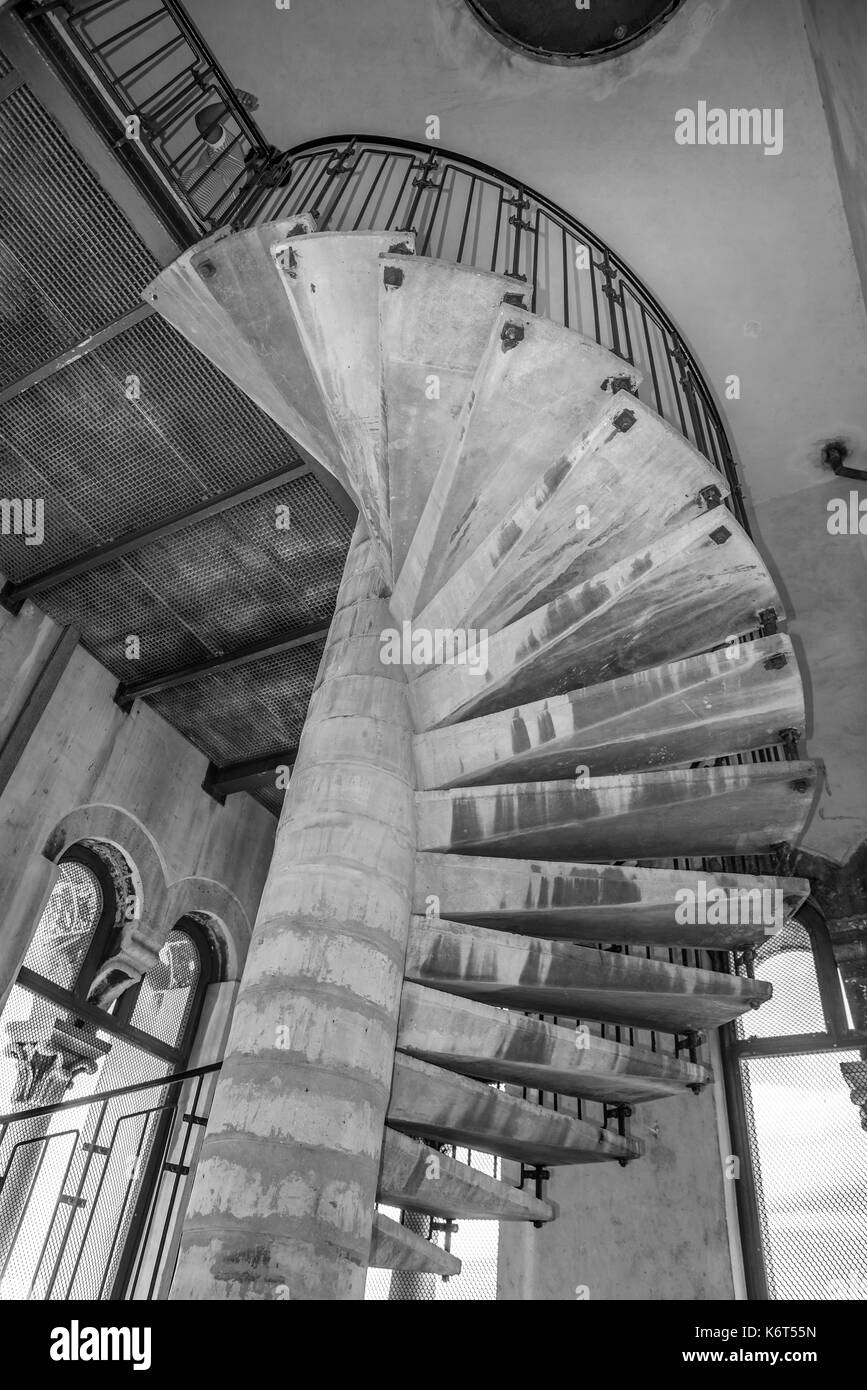 Concrete spiral staircase in a stone tower Stock Photo