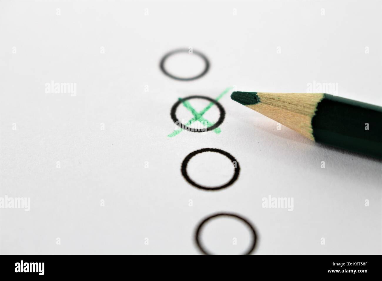 An concept Image of a green pencil and a questionnaire Stock Photo - Alamy