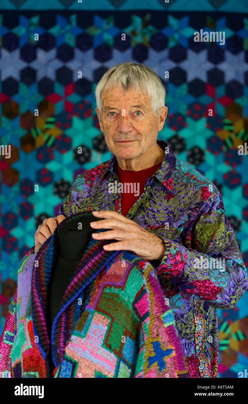 Textile artist Kaffe Fassett looks at one of his knitted coats on display during a photocall for his show 'Kaffe Fassett&Otilde;s Colour at Mottisfont', showcasing work from his career spanning 50 years at Mottisfont in Hampshire. Stock Photo